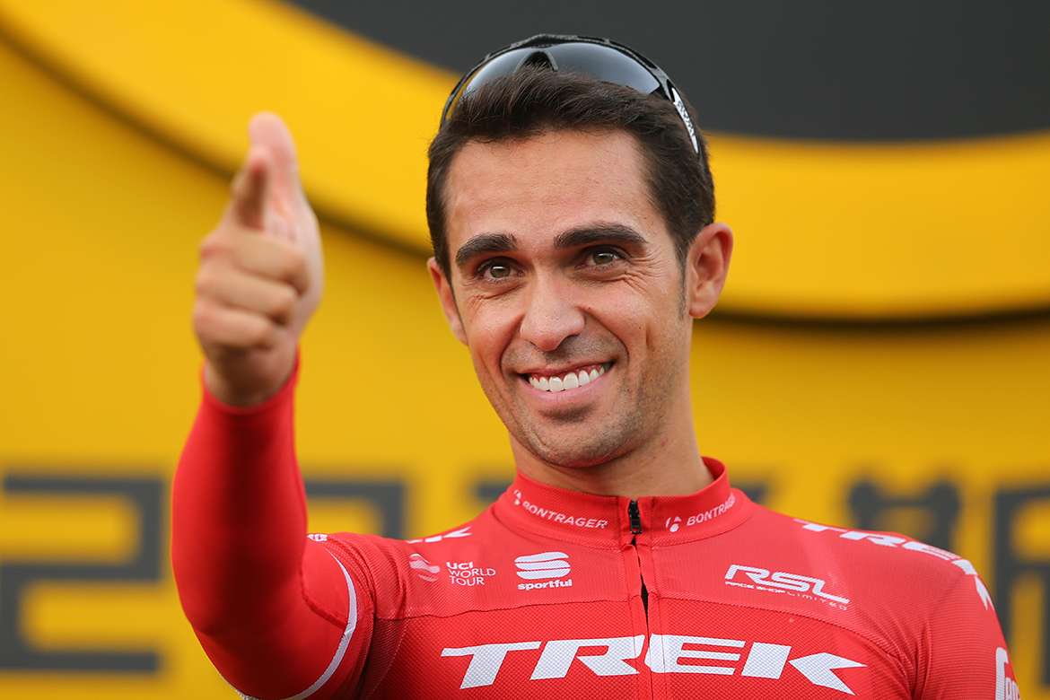 Alberto Contador mid-crash during a road race, bike skidding and dust kicked up