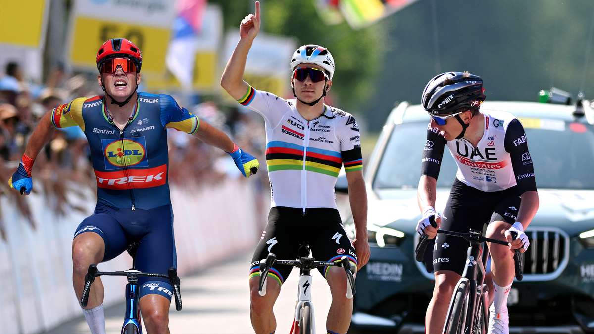 Racing cyclists powering over wet cobblestones in a Monument classic