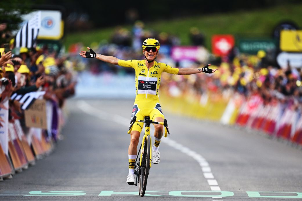 Cyclist wearing the yellow jersey on a summit finish with crowd-lined roads