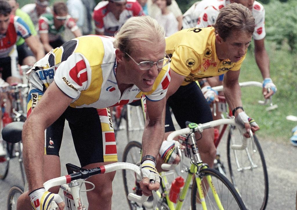 Young Laurent Fignon riding in early professional race, focused and aerodynamic in classic 1980s kit