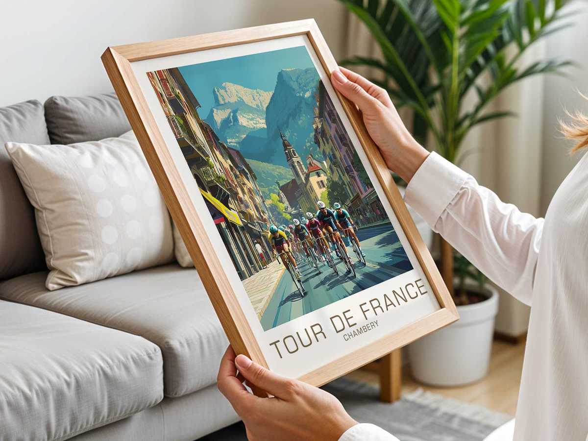 Framed view through a town gateway to distant mountains, with a foreground cyclist entering the scene in Chambéry