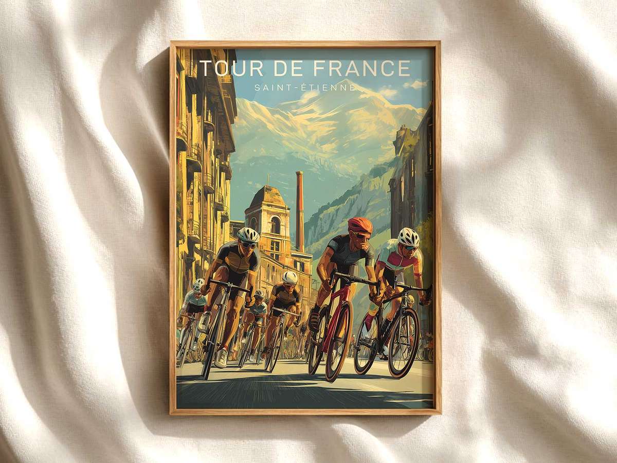 Framed vintage-style Saint-Étienne poster displayed on a neutral wall, showing a classic Tour de France cyclist silhouette…