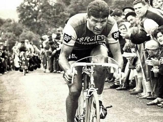 Black and white portrait of Raymond Poulidor in racing cap from the 1960s
