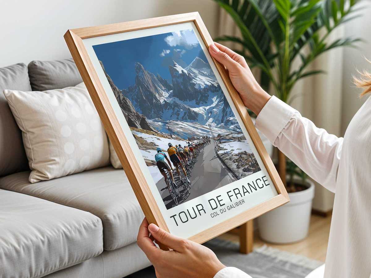 Long view of the winding Galibier road with a solitary cyclist small in the frame, emphasizing scale and resolve