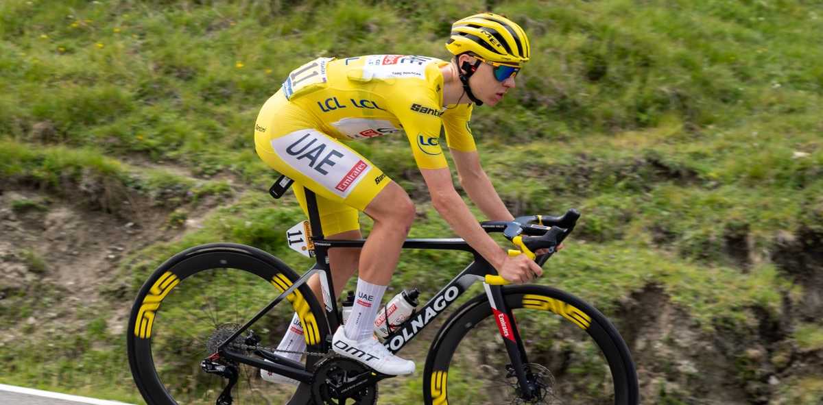 Tadej Pogačar riding uphill in training, showing climbing position and effort