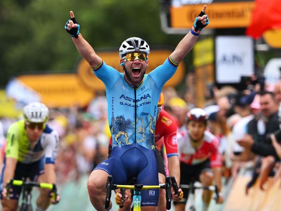A Tour de France climber powering up a steep alpine road with teammates pacing behind
