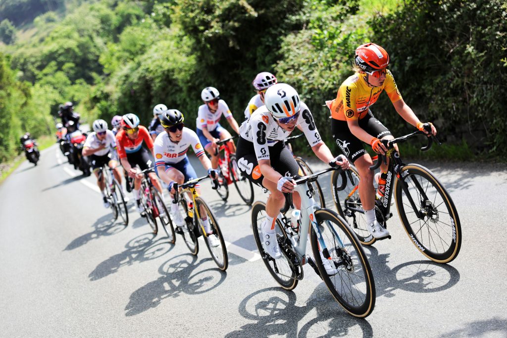 A wall calendar marked with highlighted dates for major cycling races and handwritten notes about preparation and travel